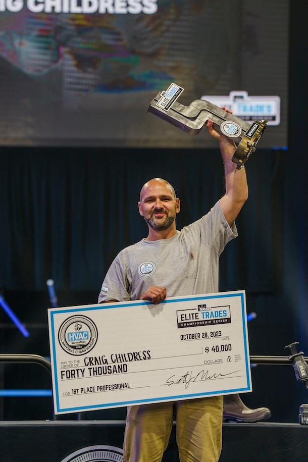 An American Standard technician is receiving a trophy