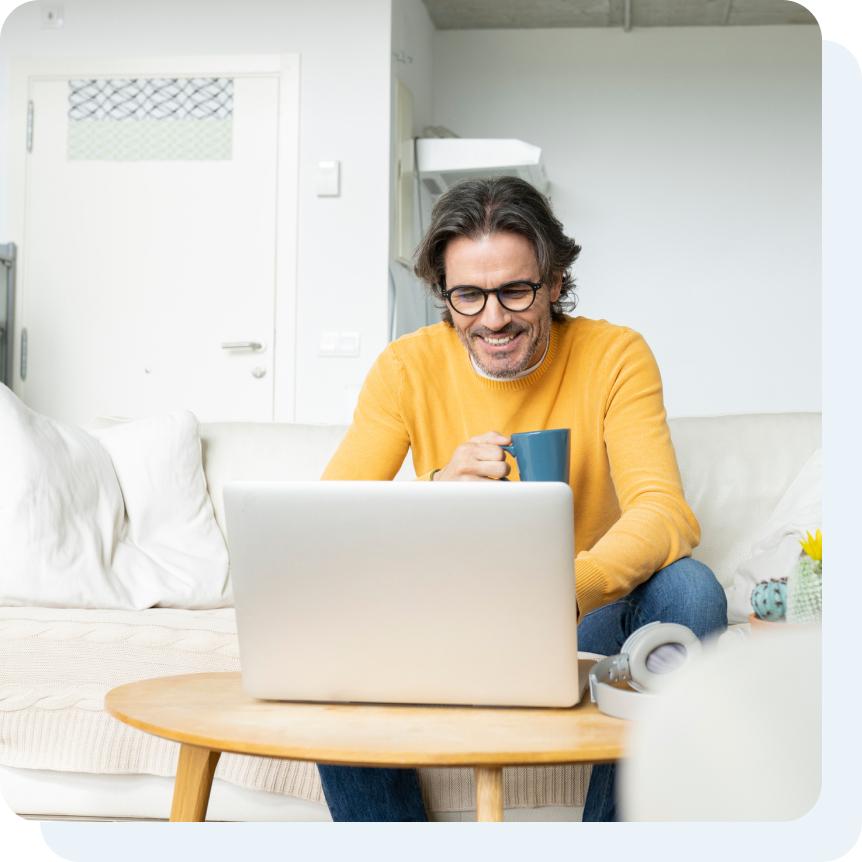 A man looking up HVAC DIY maintenance tips on a laptop computer.