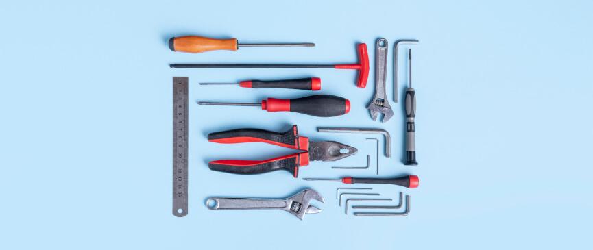 A complete set of tools is laid out against a blue background.