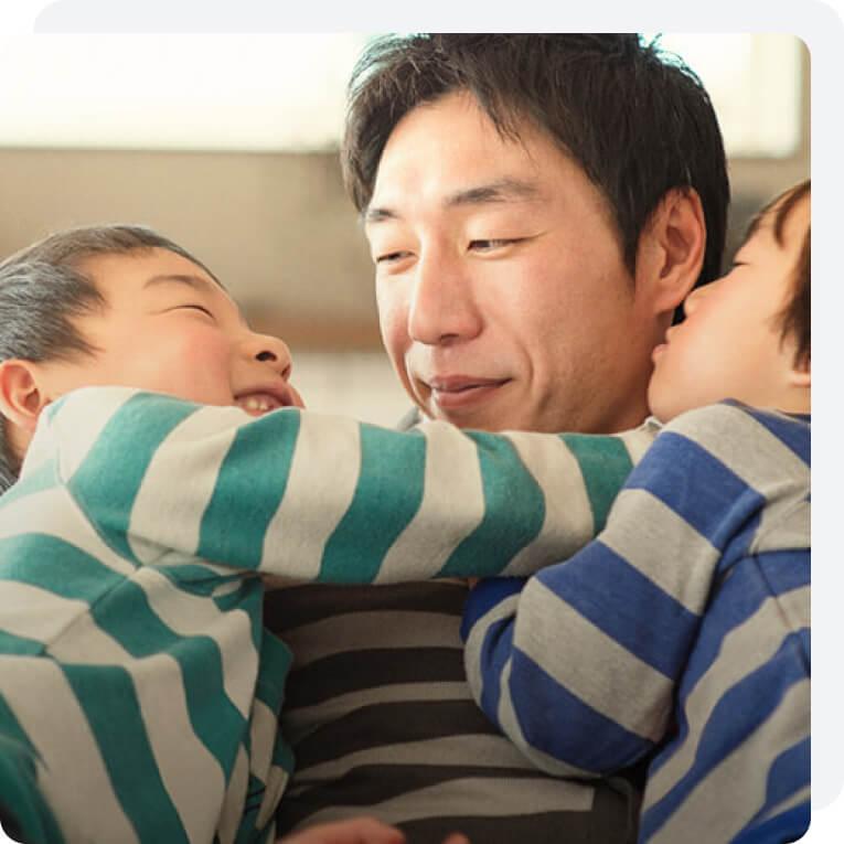 A man plays with his young sons in their comfortable home.