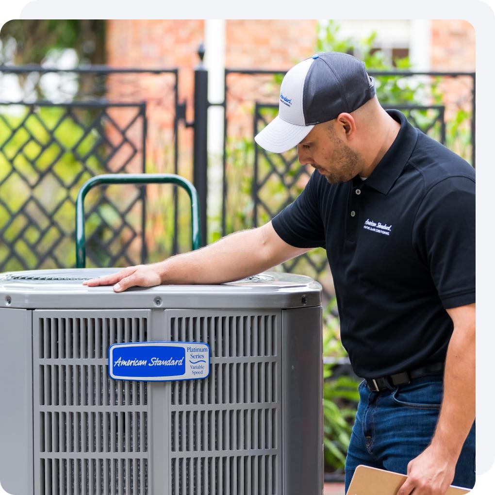 an American Standard customer care dealer with an outdoor HVAC unit.
