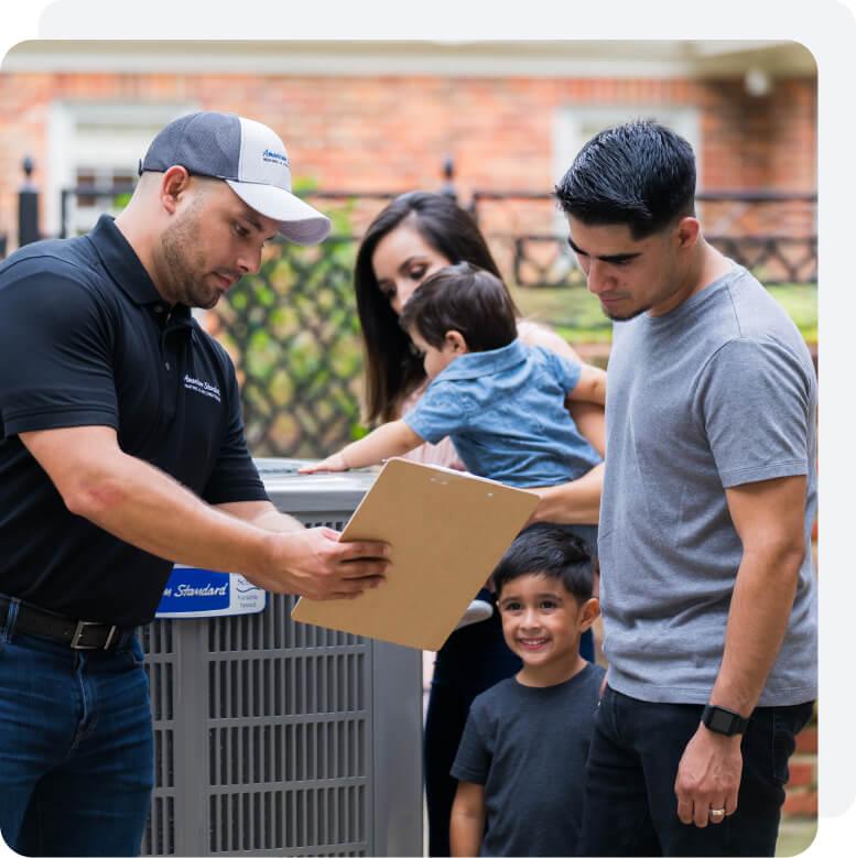 A family reviewing documentation with their HVAC dealer.