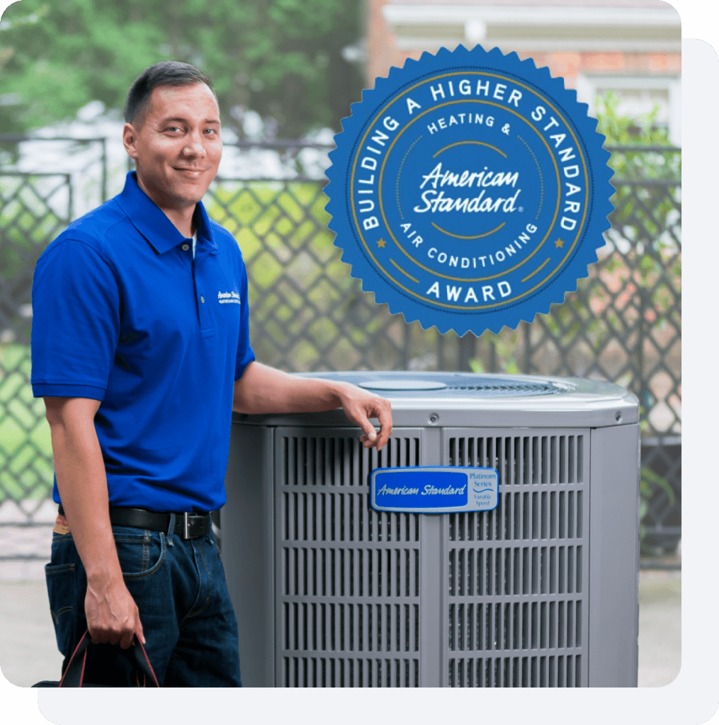 an American Standard Heating &amp; Air Conditioning dealer standing by an outdoor HVAC unit.