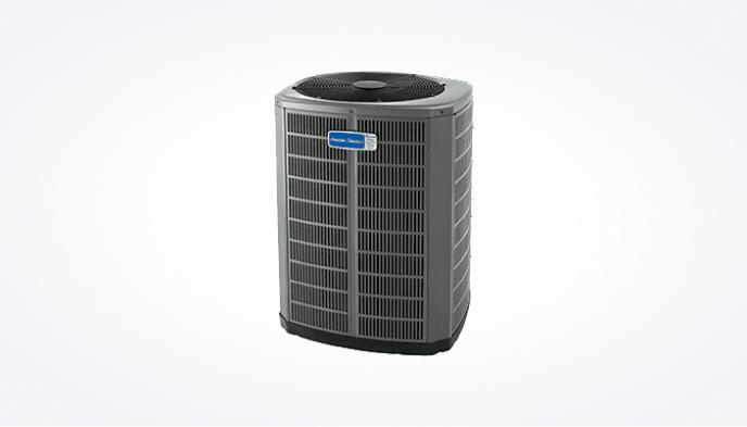 A gray heat pump with a blue American Standard logo.